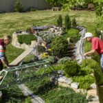 Barb and Mark Brown work on their garden railroad.