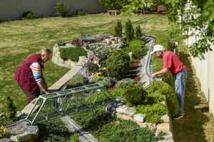 Barb and Mark Brown work on their garden railroad.