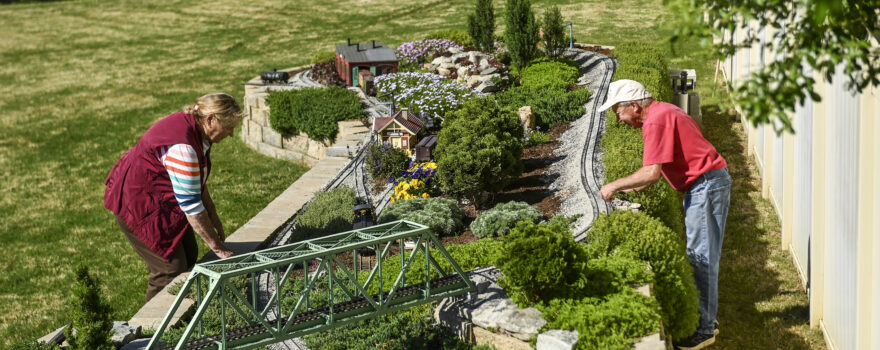Barb and Mark Brown work on their garden railroad.