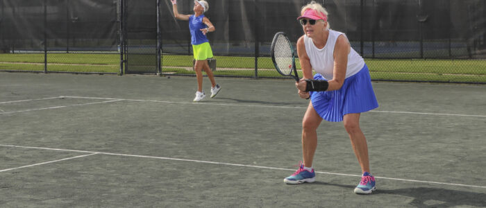 Susan Canada serves and Marsha Purcell prepares for the return