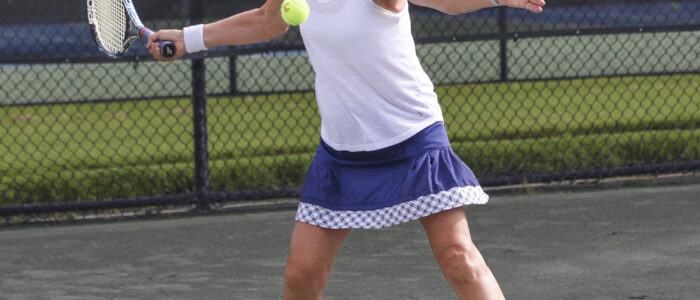 Debra Crowell hits a forehand shot