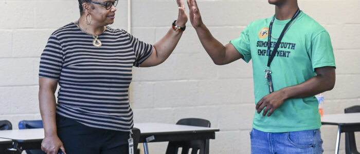 Shannon Shackelford high-fives Ta’Veon Goldsmith