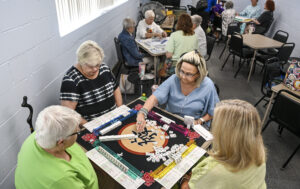 Mahjong enthusiasts play the tile-based game