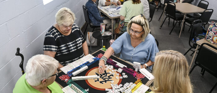 Mahjong enthusiasts play the tile-based game