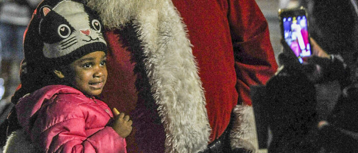 Charlie Gholston, 4, poses with Santa during the downtown Christmas open house and tree lighting ceremony. [JERONIMO NISA]