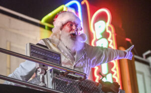 Santa (Paul Martin) rides by Princess Theatre in a fire truck during the 2022 Decatur Christmas parade.
