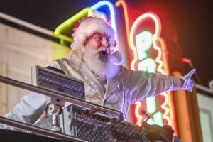 Santa (Paul Martin) rides by Princess Theatre in a fire truck during the 2022 Decatur Christmas parade.