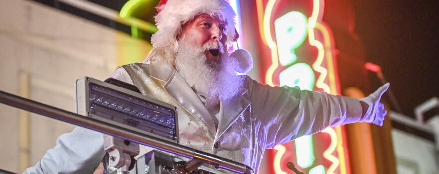 Santa (Paul Martin) rides by Princess Theatre in a fire truck during the 2022 Decatur Christmas parade.
