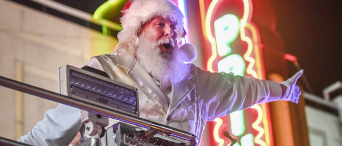 Santa (Paul Martin) rides by Princess Theatre in a fire truck during the 2022 Decatur Christmas parade.