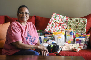 Tracey Cater poses with gifts waiting to be wrapped.