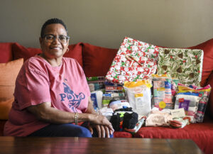 Tracey Cater poses with gifts waiting to be wrapped.
